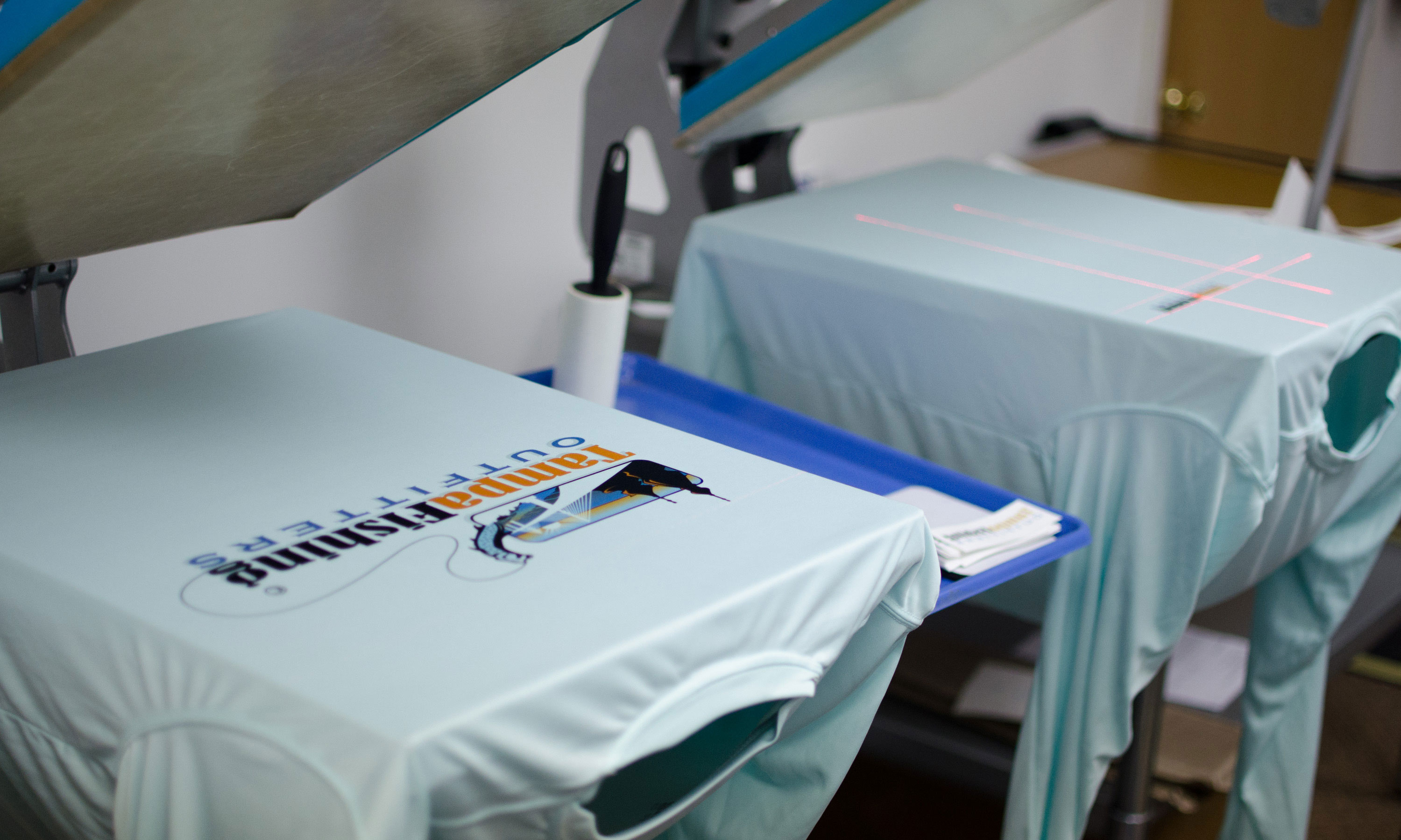 Shirts on a heatpress after sublimation printing